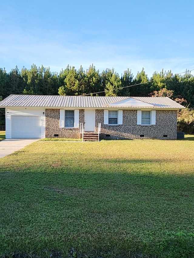 ranch-style house featuring a garage and a front yard