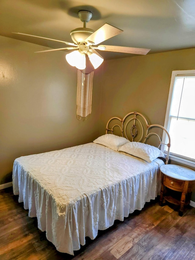 bedroom with ceiling fan and dark wood-type flooring