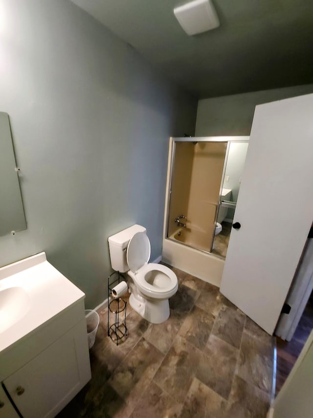 full bathroom featuring vanity, toilet, and enclosed tub / shower combo