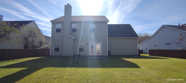 rear view of property featuring a yard