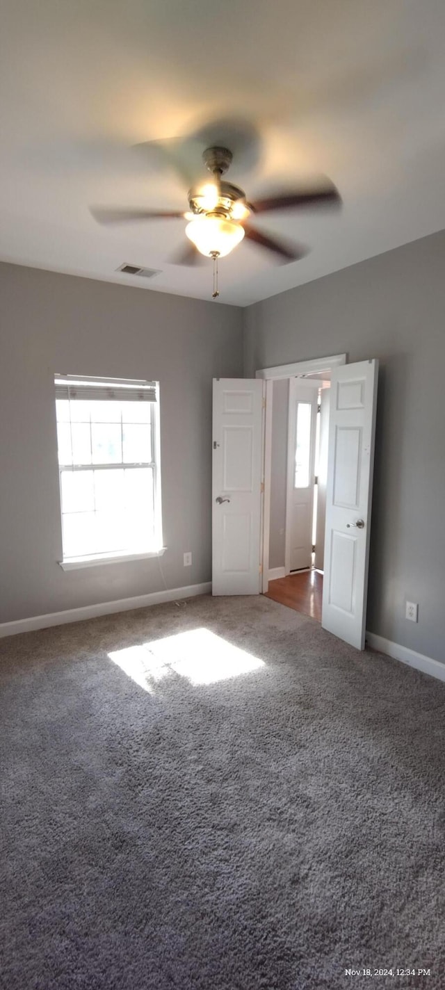 unfurnished bedroom featuring carpet flooring and ceiling fan