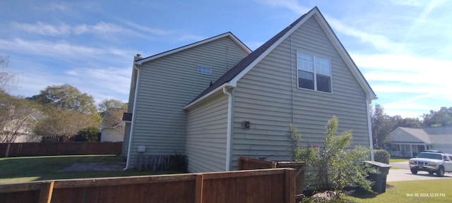 view of side of property featuring a yard