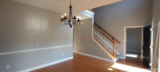 interior space with hardwood / wood-style floors and an inviting chandelier