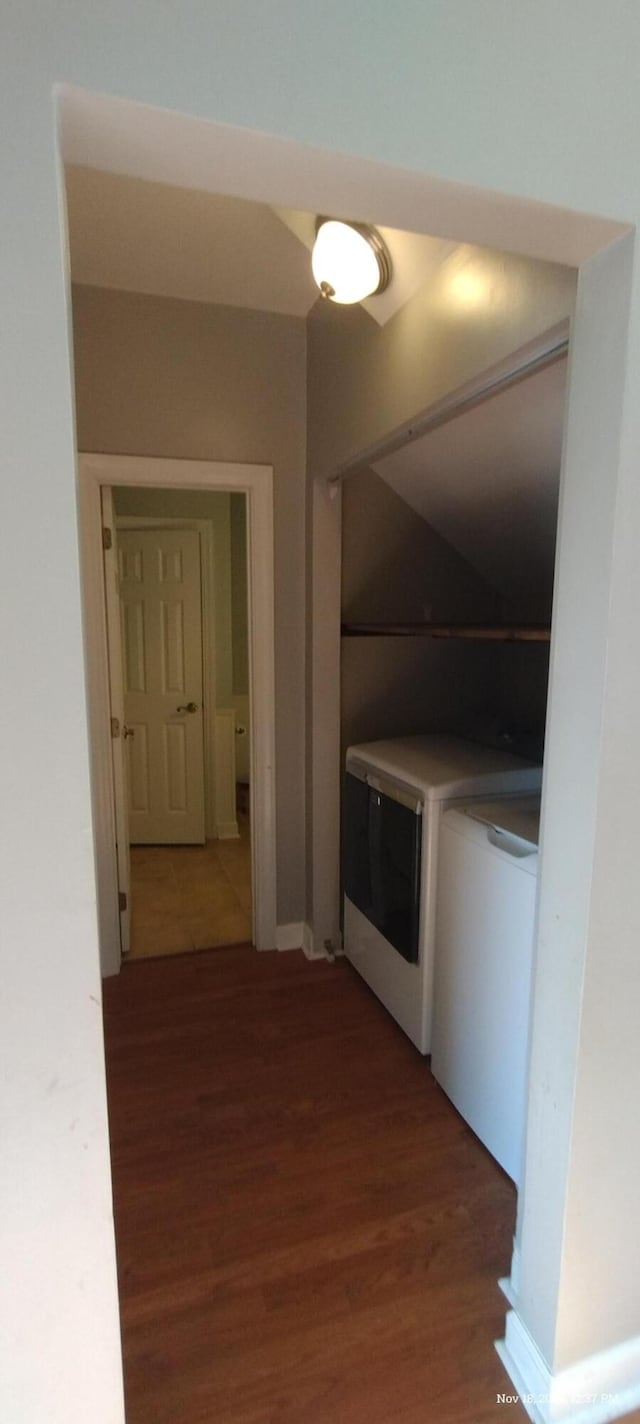 interior space featuring dark hardwood / wood-style floors and washing machine and clothes dryer