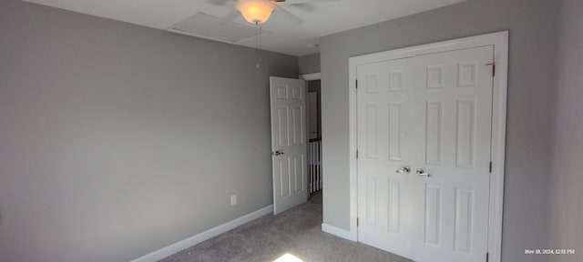 unfurnished bedroom with light carpet, a closet, and ceiling fan