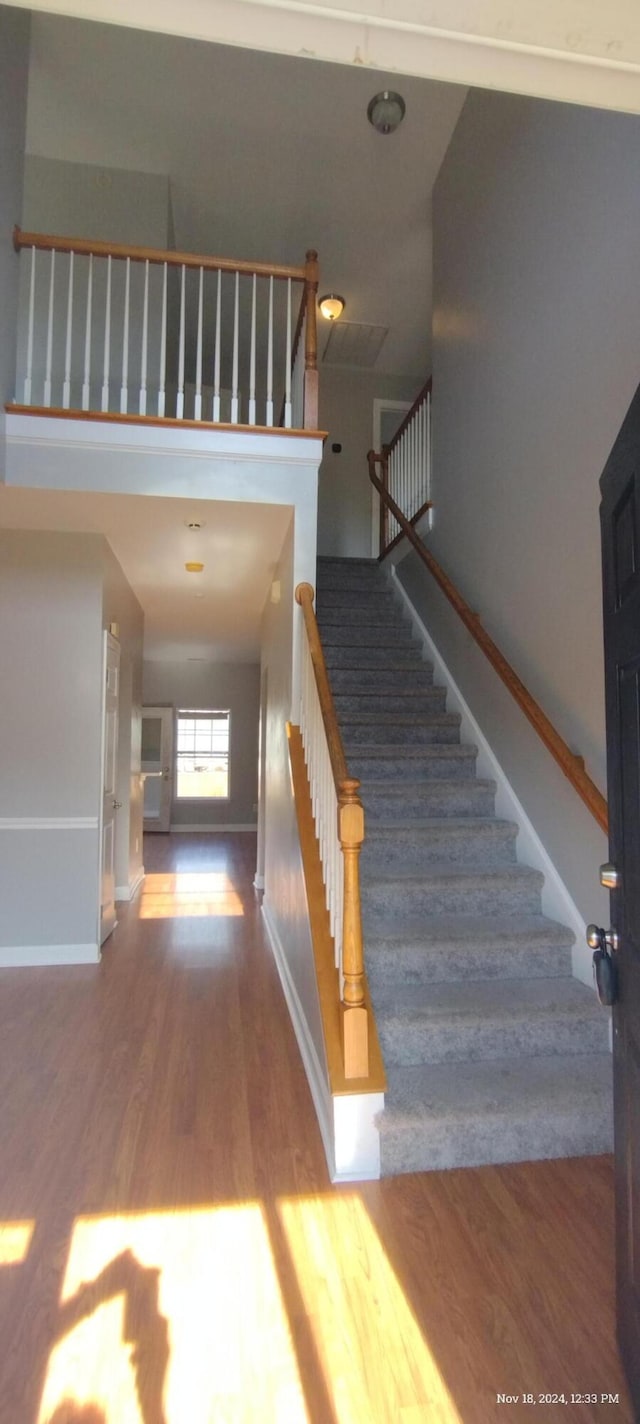 stairs featuring hardwood / wood-style flooring