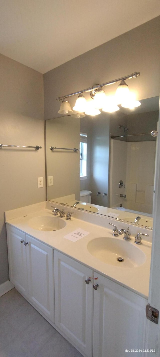 full bathroom featuring vanity, shower / bathtub combination, and toilet