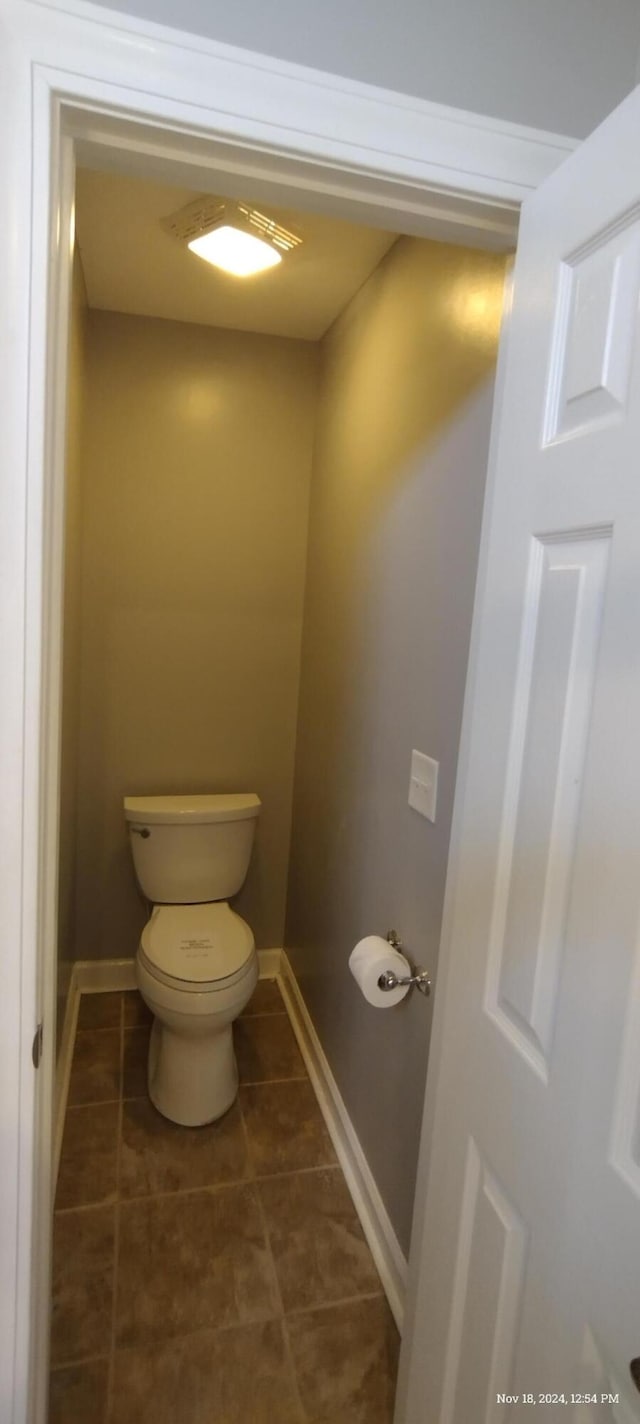 bathroom with tile patterned flooring and toilet