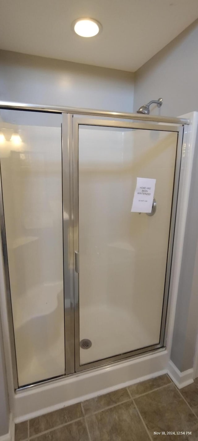 bathroom featuring tile patterned flooring and walk in shower