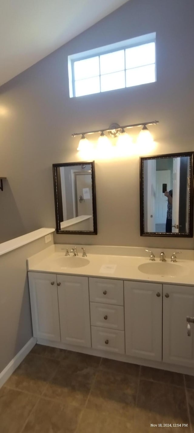 bathroom featuring tile patterned flooring, vanity, and lofted ceiling