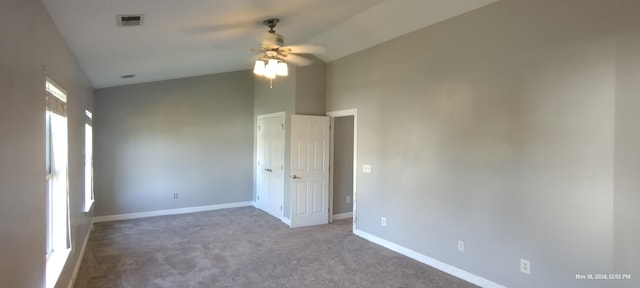 empty room with carpet, ceiling fan, and vaulted ceiling