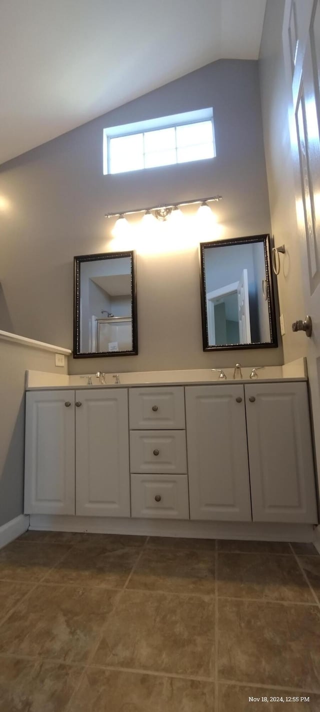 bathroom featuring vanity and vaulted ceiling