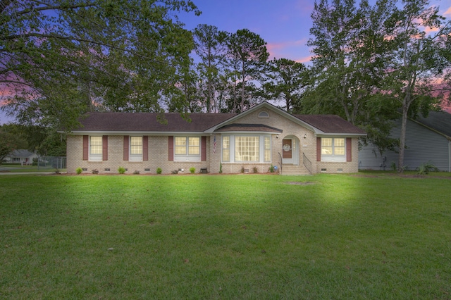 single story home featuring a yard