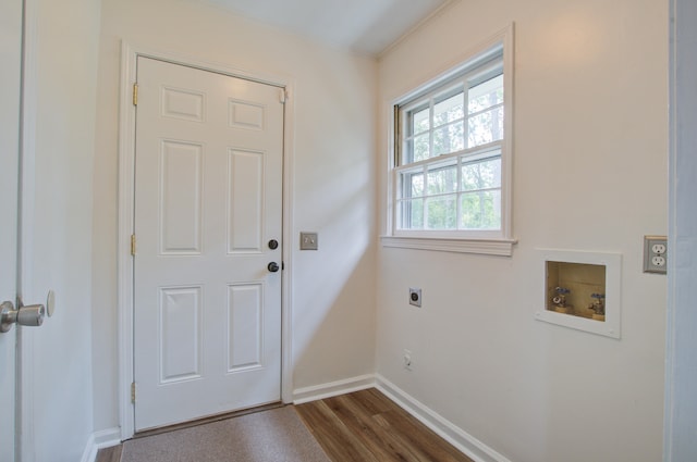 entryway with ornamental molding and dark hardwood / wood-style flooring