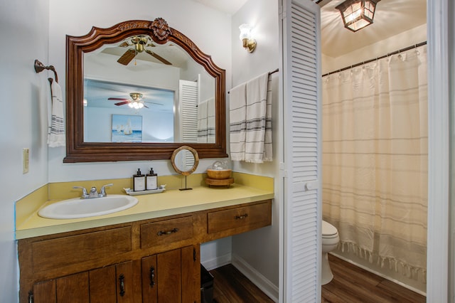 bathroom with hardwood / wood-style floors, ceiling fan, toilet, and vanity