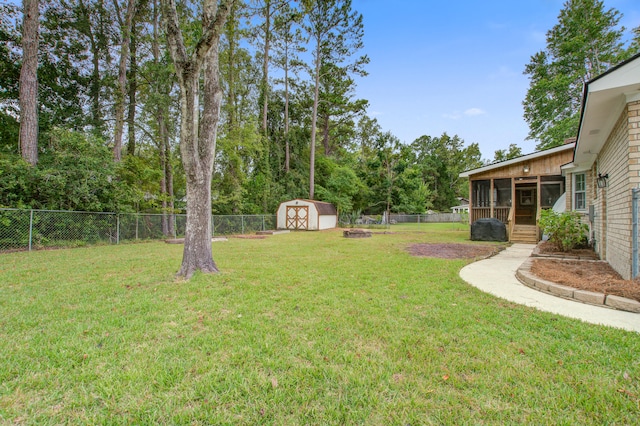 view of yard featuring a shed and a sunroom