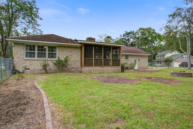 exterior space featuring a sunroom and a front lawn