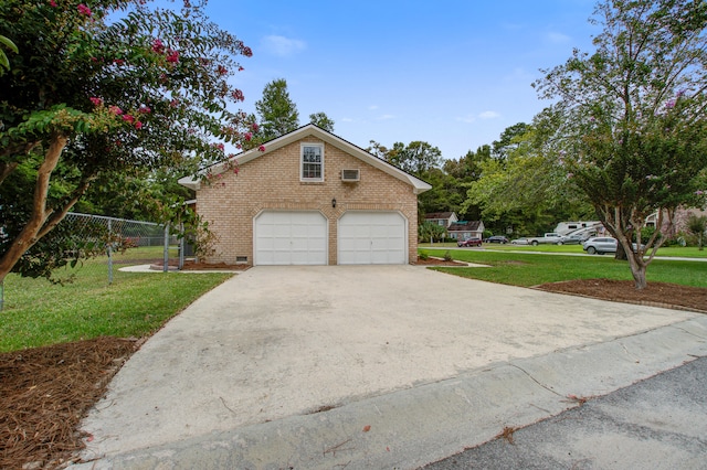 view of front of house featuring a garage and a front lawn