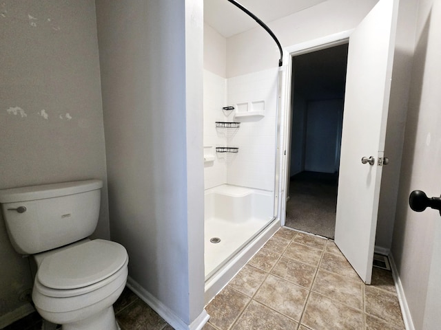 bathroom featuring toilet and a shower