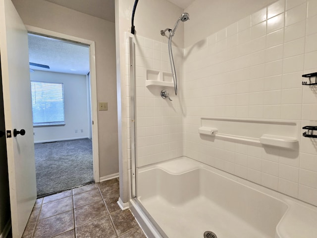 bathroom featuring a textured ceiling, tile patterned floors, and a shower