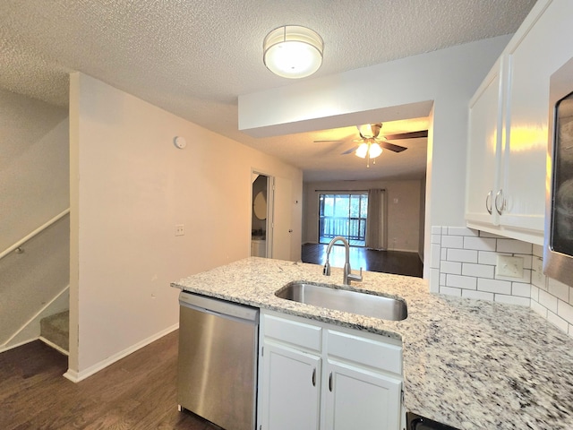 kitchen with decorative backsplash, sink, white cabinets, and stainless steel dishwasher