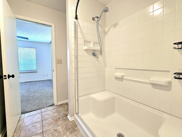 bathroom featuring a shower, tile patterned floors, and a textured ceiling