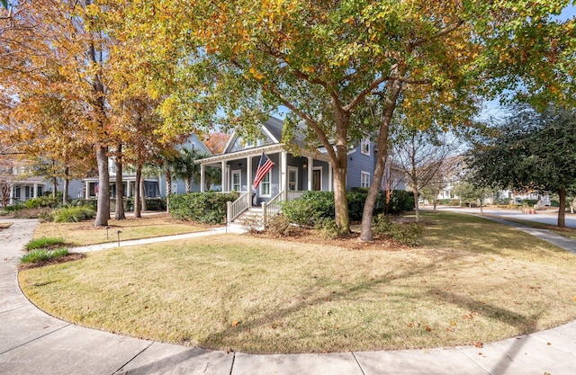 obstructed view of property featuring covered porch and a front yard