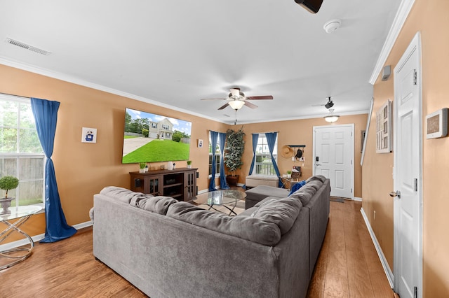 living room featuring light hardwood / wood-style flooring, ceiling fan, and ornamental molding