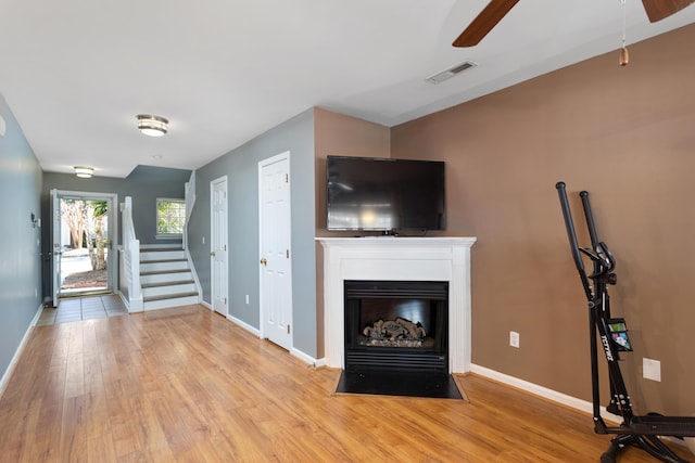 unfurnished living room featuring ceiling fan and light wood-type flooring