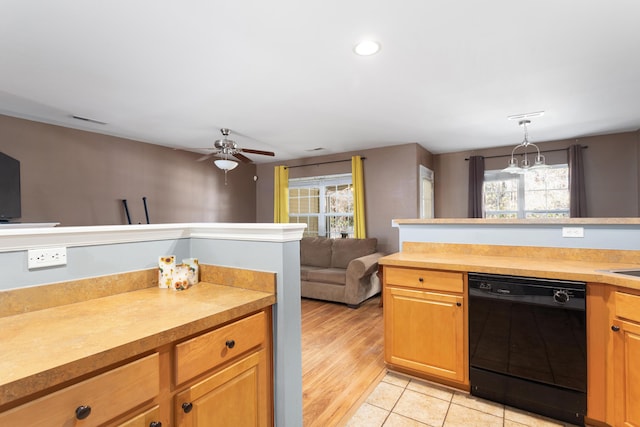 kitchen with dishwasher, light tile patterned floors, ceiling fan, and decorative light fixtures