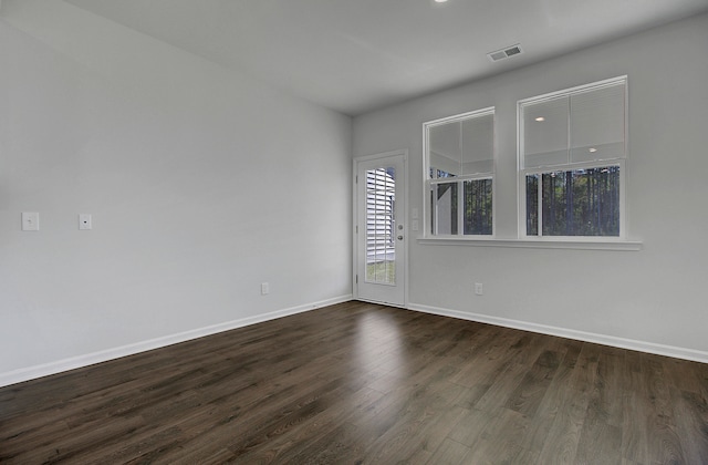 unfurnished room featuring dark hardwood / wood-style floors