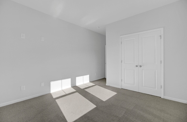 unfurnished bedroom with a closet and carpet