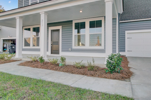 entrance to property with a porch and a garage