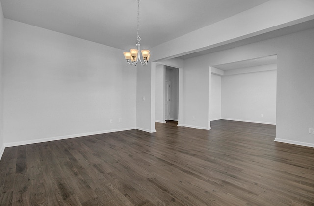 interior space with a notable chandelier and dark hardwood / wood-style floors