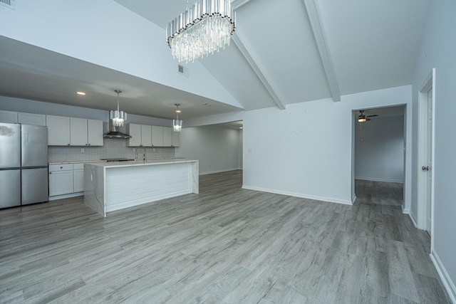 133 Marion Rd, Summerville, SC 29486 - kitchen featuring open floor plan, light countertops, light wood-style floors, freestanding refrigerator, and wall chimney exhaust hood