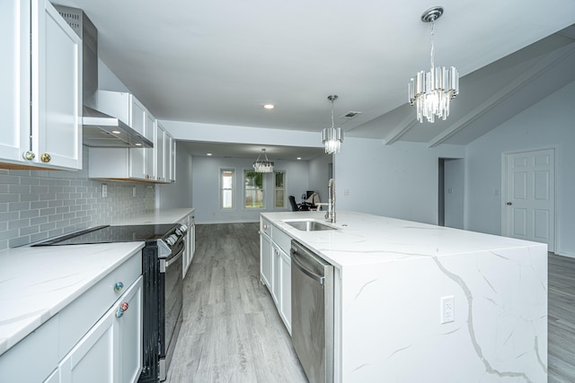 kitchen featuring white cabinets, pendant lighting, stainless steel appliances, and a kitchen island with sink