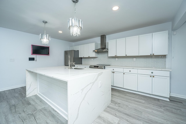 133 Marion Rd, Summerville, SC 29486 - kitchen featuring a chandelier, a kitchen island with sink, stainless steel appliances, wall chimney exhaust hood, and backsplash
