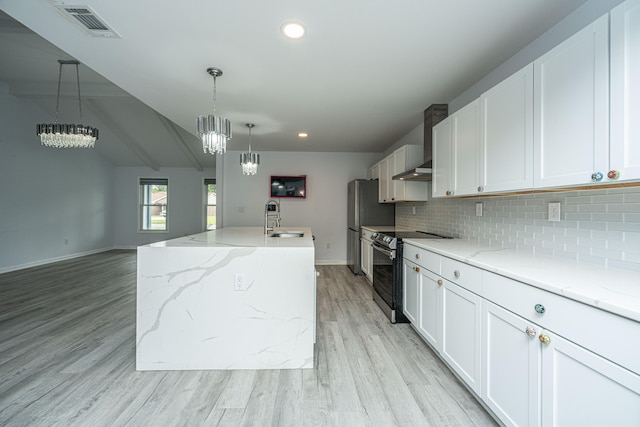 kitchen featuring wall chimney exhaust hood, appliances with stainless steel finishes, and white cabinetry