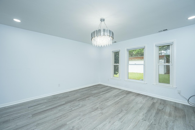 133 Marion Rd, Summerville, SC 29486 - spare room with baseboards, visible vents, a notable chandelier, and wood finished floors