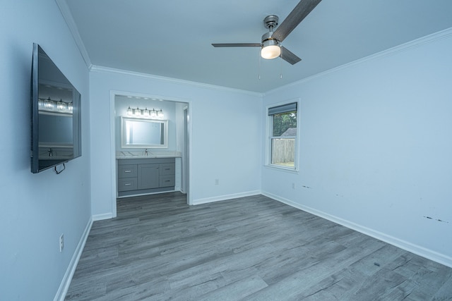 unfurnished bedroom with ceiling fan, ornamental molding, ensuite bath, and light hardwood / wood-style flooring