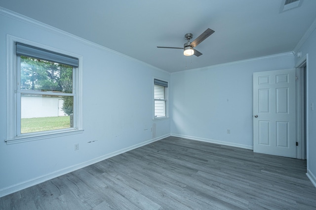 empty room featuring crown molding, ceiling fan, and wood-type flooring