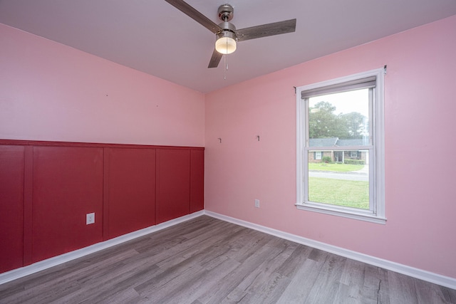 unfurnished room featuring a wealth of natural light, ceiling fan, and light hardwood / wood-style floors