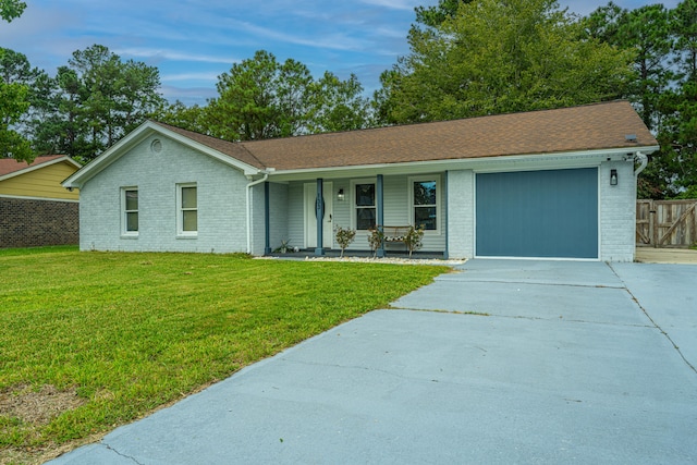 ranch-style house with a garage, covered porch, and a front lawn