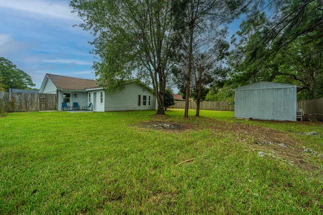 view of yard featuring a storage shed and a patio area