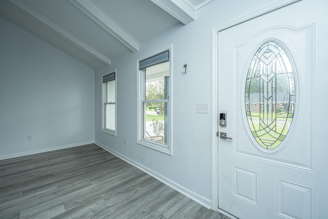 foyer entrance featuring hardwood / wood-style floors and vaulted ceiling with beams