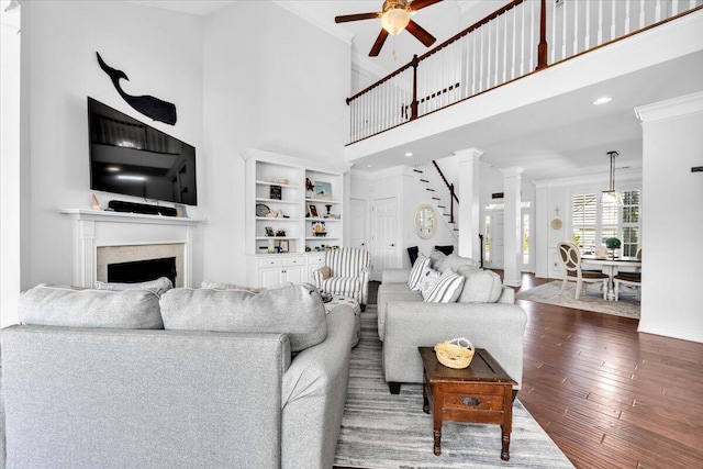 1003 Jervey Point Rd, Wando, SC 29492 - living area with ceiling fan, hardwood / wood-style floors, a fireplace, a high ceiling, and baseboards