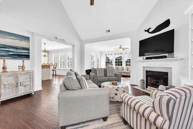 1003 Jervey Point Rd, Wando, SC 29492 - living area with dark wood-type flooring, a fireplace with flush hearth, a ceiling fan, high vaulted ceiling, and baseboards