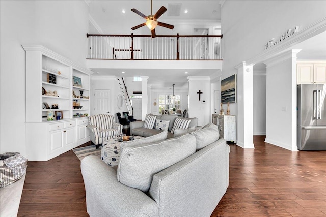 1003 Jervey Point Rd, Wando, SC 29492 - living room with ceiling fan, a high ceiling, ornate columns, ornamental molding, and dark wood-style floors