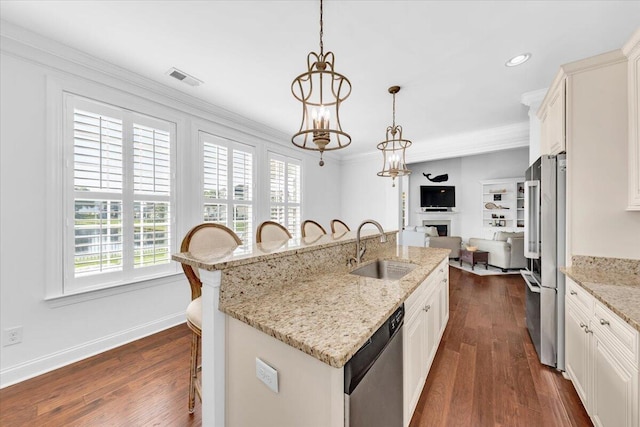 1003 Jervey Point Rd, Wando, SC 29492 - kitchen featuring a sink, stainless steel appliances, a kitchen breakfast bar, a fireplace, and a center island with sink