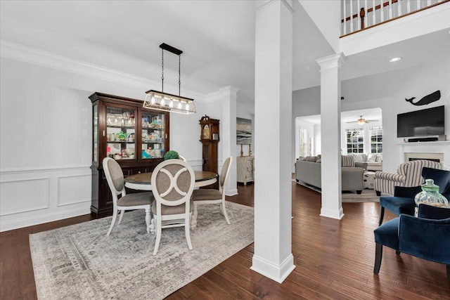 1003 Jervey Point Rd, Wando, SC 29492 - dining area with decorative columns, ceiling fan, dark wood-style floors, ornamental molding, and a fireplace